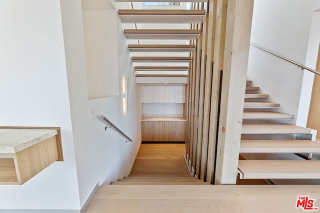 stairs with hardwood / wood-style floors