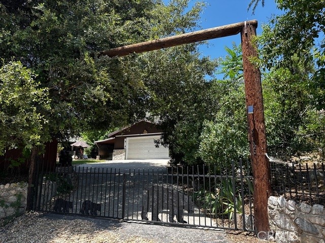 view of property hidden behind natural elements with a garage