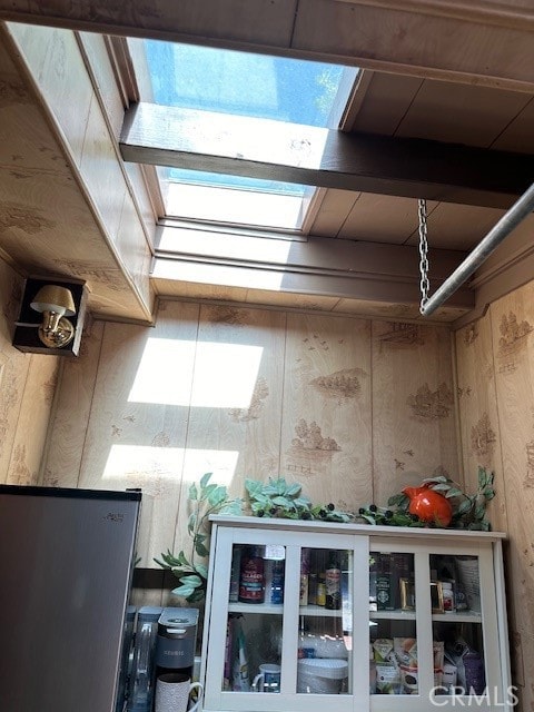 interior details featuring wood walls and beam ceiling