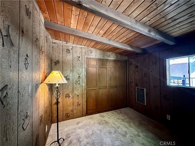 interior space featuring wooden walls, beamed ceiling, and carpet flooring