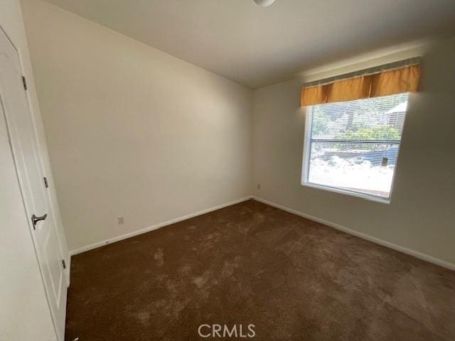 41501 Island Dr, Forest Falls, CA 92339 - unfurnished room featuring dark carpet and baseboards