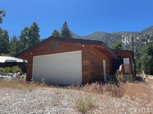 41501 Island Dr, Forest Falls, CA 92339 - view of home's exterior featuring an outbuilding, a mountain view, and a garage
