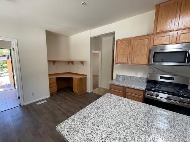 41501 Island Dr, Forest Falls, CA 92339 - kitchen with light stone counters, visible vents, dark wood-style floors, and stainless steel appliances