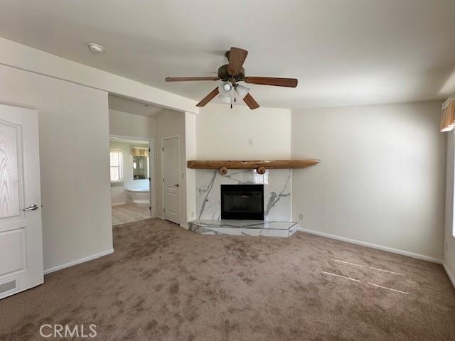 41501 Island Dr, Forest Falls, CA 92339 - unfurnished living room with carpet, a ceiling fan, baseboards, and a fireplace