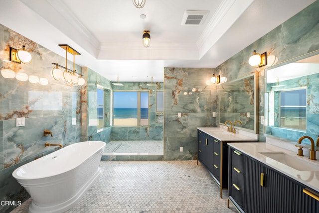 bathroom with vanity, separate shower and tub, a tray ceiling, tile walls, and crown molding