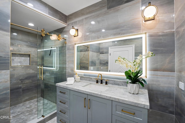 bathroom featuring vanity, tile walls, and an enclosed shower