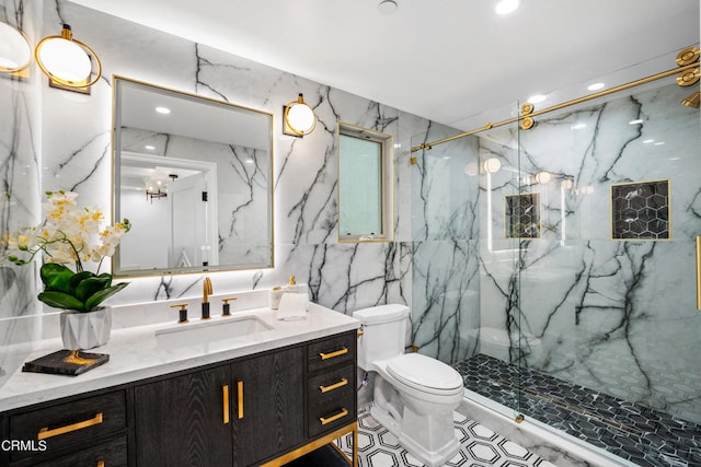 bathroom with tile walls, vanity, toilet, and a shower with door