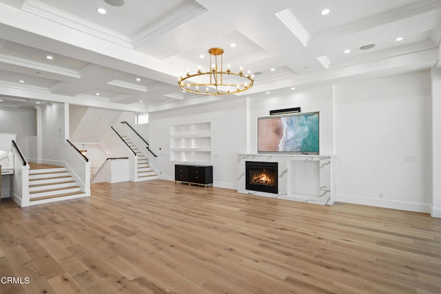 unfurnished living room with beamed ceiling, light hardwood / wood-style floors, coffered ceiling, and a fireplace