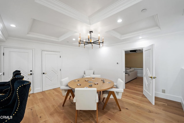 dining space featuring an inviting chandelier, light hardwood / wood-style flooring, and ornamental molding