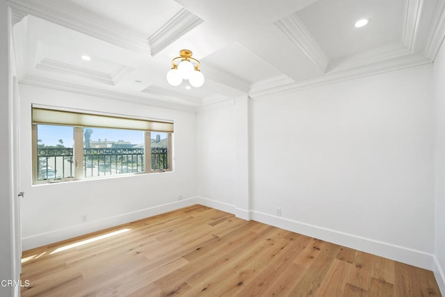 spare room featuring beam ceiling, light hardwood / wood-style floors, ornamental molding, and an inviting chandelier