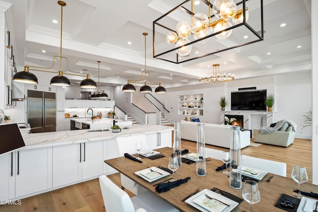 dining room with light wood-type flooring, a chandelier, beamed ceiling, coffered ceiling, and crown molding