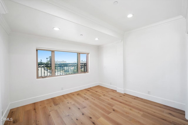 unfurnished room featuring wood-type flooring and crown molding