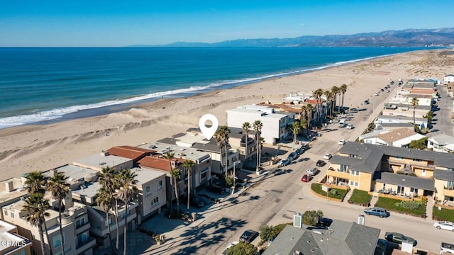 bird's eye view with a water view and a beach view