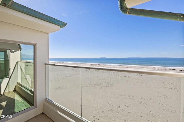 exterior space with a beach view and a water view