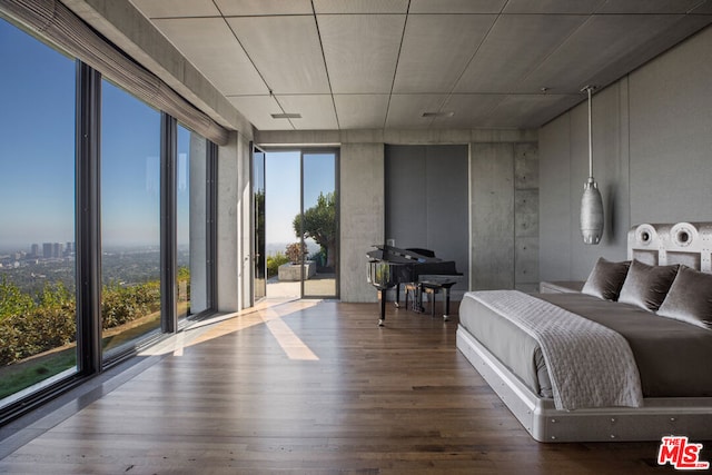 bedroom with a wall of windows, access to exterior, and wood-type flooring