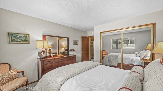 bedroom with a closet, carpet floors, and a textured ceiling