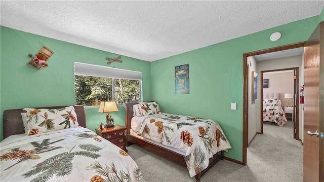 bedroom featuring a textured ceiling and light colored carpet