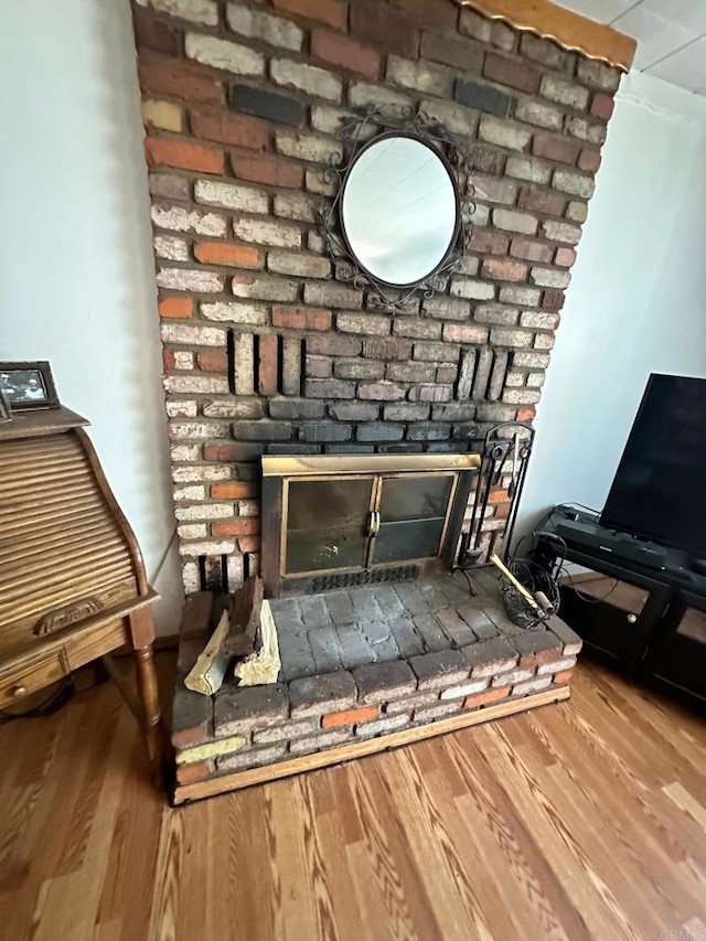 room details featuring a fireplace and hardwood / wood-style flooring