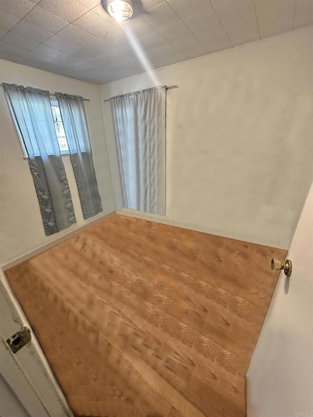 empty room with hardwood / wood-style flooring