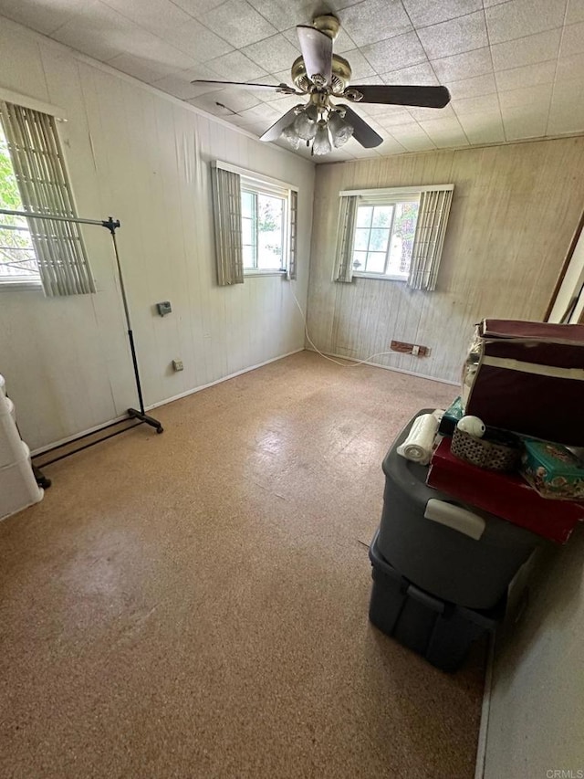 interior space with ceiling fan