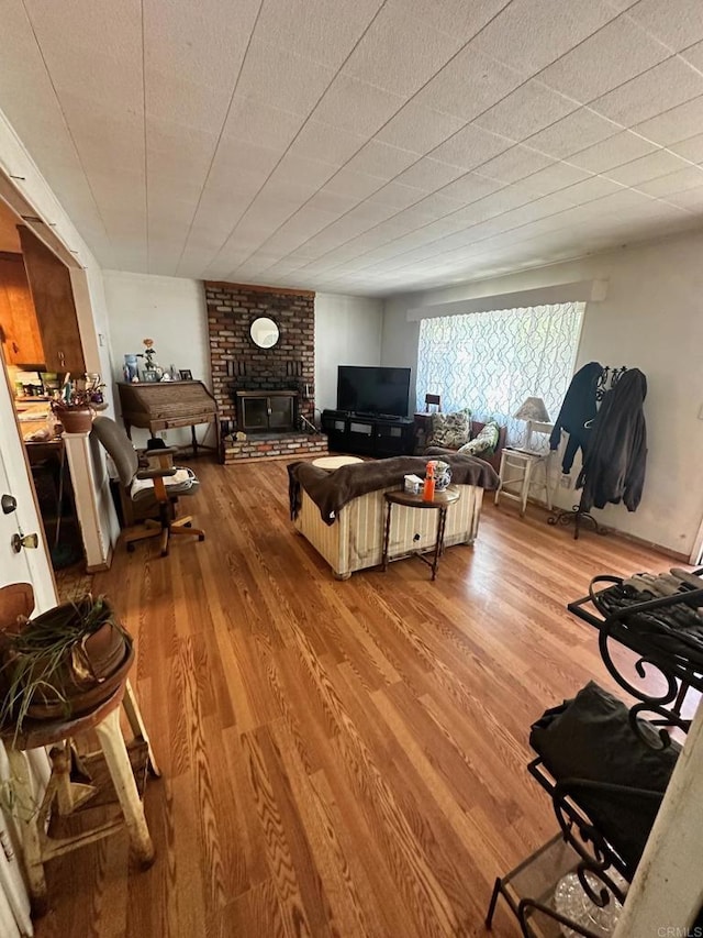 living room with a fireplace and hardwood / wood-style flooring