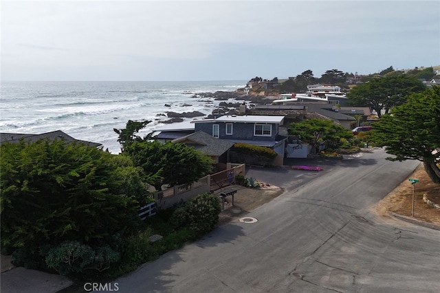 aerial view with a water view and a beach view