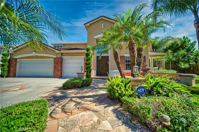 mediterranean / spanish home with a garage