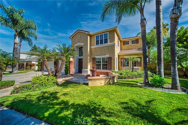 view of front of home with a garage and a front lawn