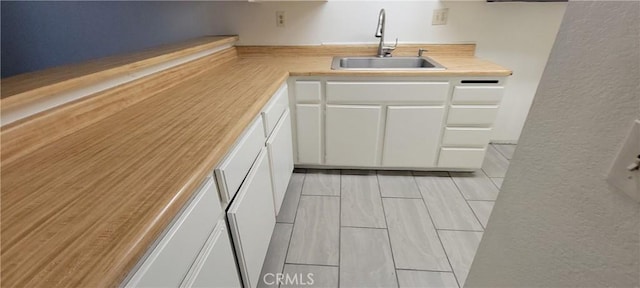 kitchen with white cabinetry and sink