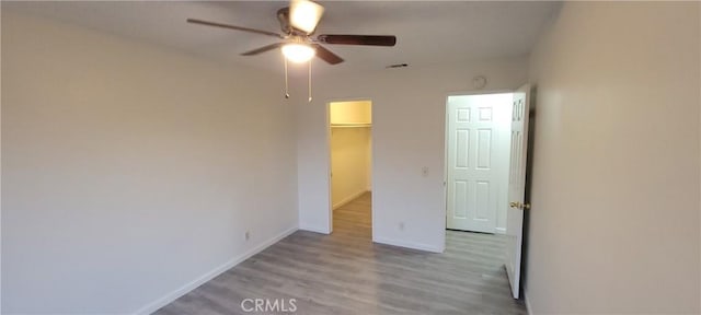 spare room with light hardwood / wood-style flooring and ceiling fan