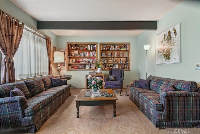 living room with beam ceiling and light colored carpet