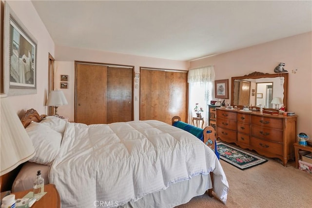 carpeted bedroom with two closets