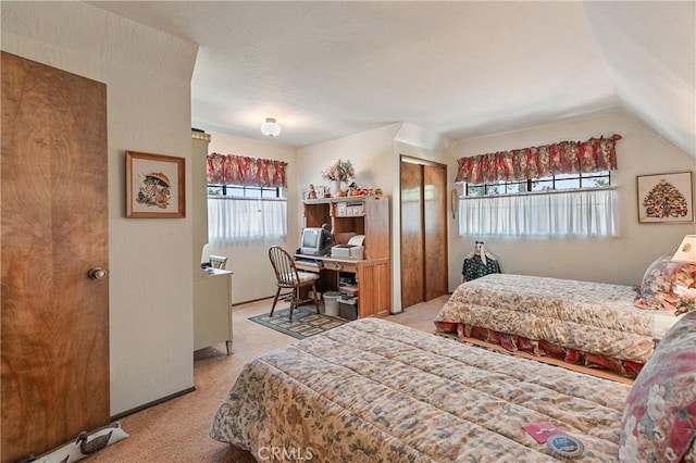 bedroom with light carpet, multiple windows, and lofted ceiling