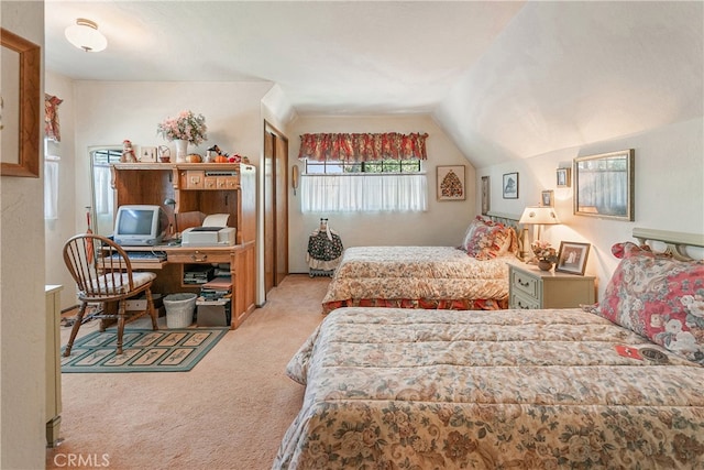 bedroom with light colored carpet and lofted ceiling