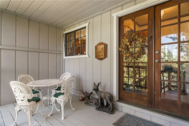 exterior space with covered porch and french doors