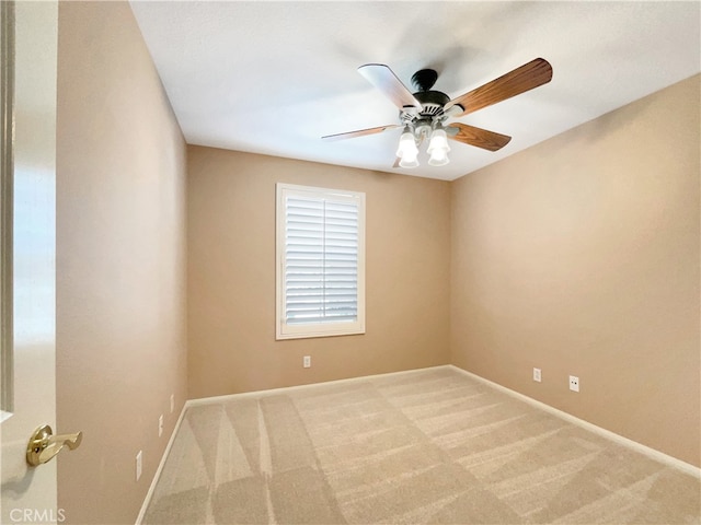 spare room featuring ceiling fan and carpet flooring