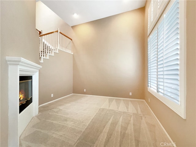 unfurnished living room with carpet flooring