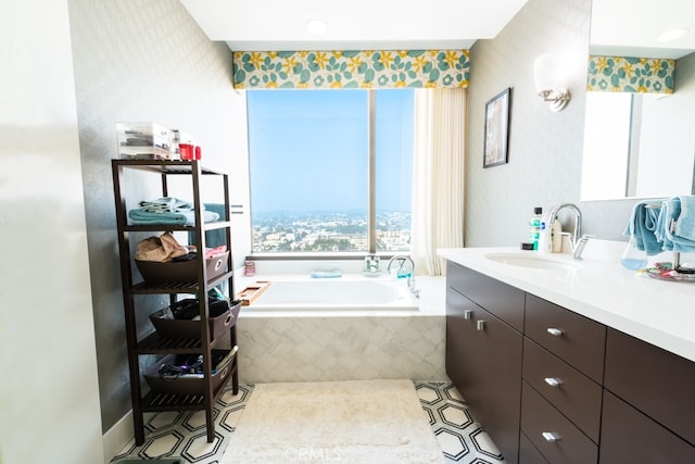 bathroom with vanity and tiled bath