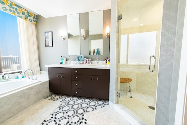 full bathroom with a shower stall, a garden tub, and a sink