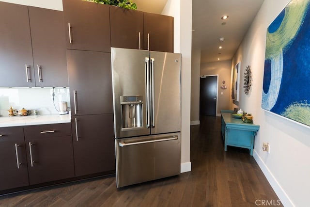 kitchen featuring recessed lighting, dark wood finished floors, stainless steel fridge with ice dispenser, light countertops, and baseboards