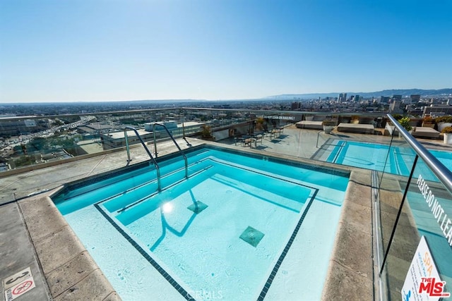 community pool featuring a view of city