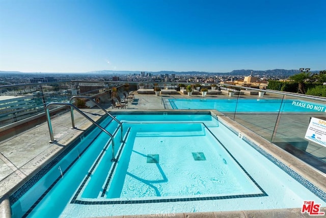 community pool with a mountain view