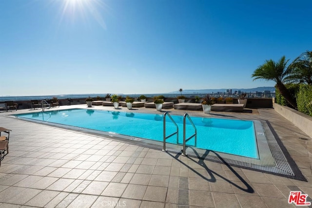 pool featuring outdoor lounge area and a patio