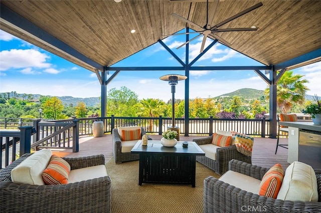 view of patio featuring outdoor lounge area and a deck with mountain view