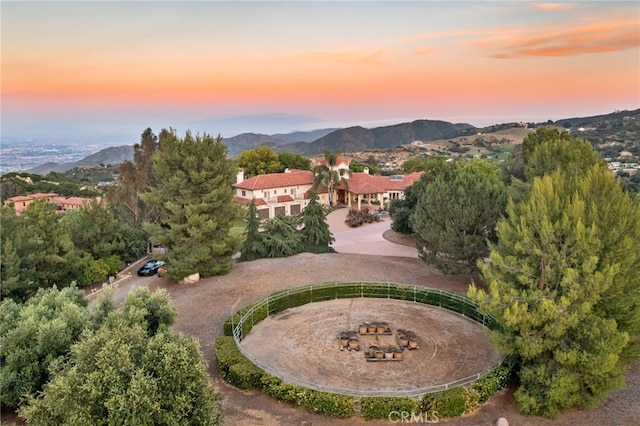 aerial view at dusk featuring a mountain view