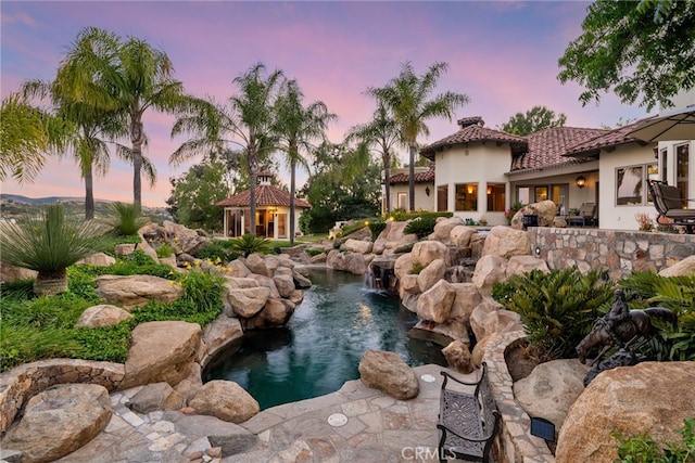 yard at dusk with a garden pond