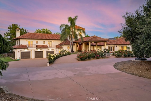 mediterranean / spanish home with a garage