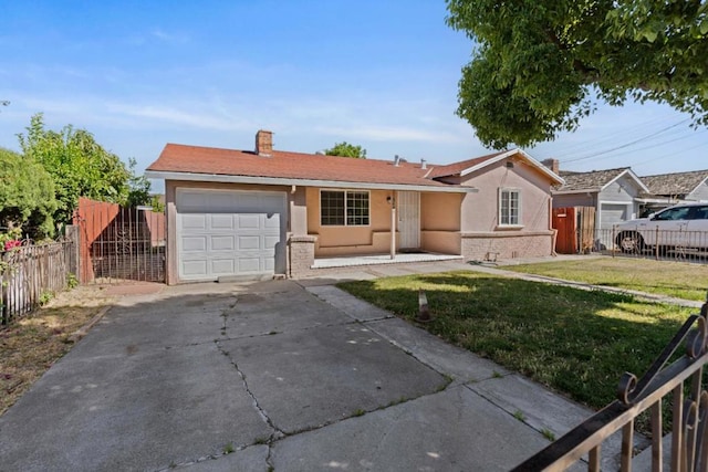 ranch-style home featuring a garage and a front lawn