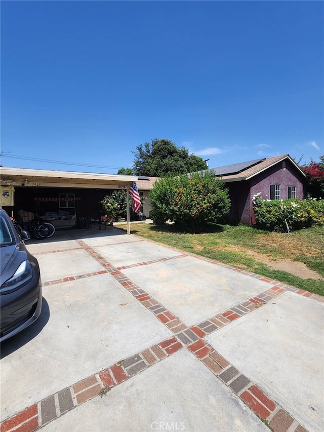 exterior space featuring a front yard and concrete driveway