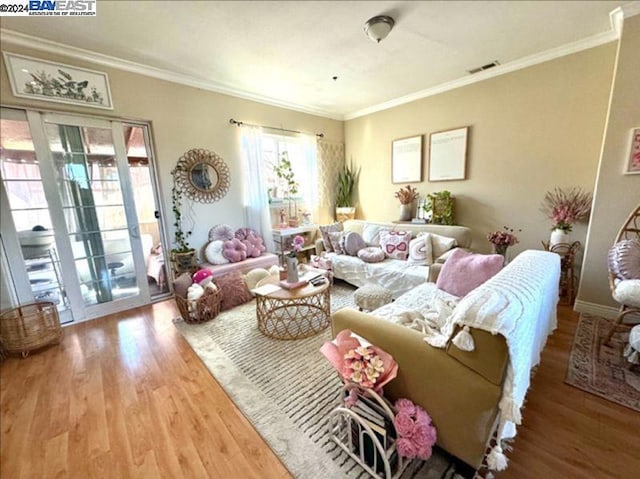 living room featuring ornamental molding and wood-type flooring